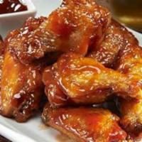 Traditional Bone-in Wings · Pick a seasoning served naked, hot, sweet or teriyaki with a side of ranch dipping sauce.