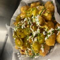 Loaded Tater Tots · Tator tots topped with cheese sauce, bacon, pickled jalapeno, sour cream