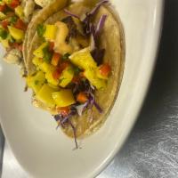 Fish Tacos · 3 tacos with blackened cod, mango salsa, sriracha aioli, cabbage, with your choice of corn o...