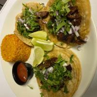 Carne Asada Tacos · 3 tacos with marinated skirt steak, pico de gallo, grilled onions, guacamole, with your choi...