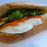 11. Egg Sandwich · Eggs, marinated carrots and daikons, cilantro, cucumber, jalapenos in hot french baguette.