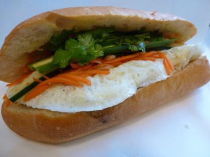 11. Egg Sandwich · Eggs, marinated carrots and daikons, cilantro, cucumber, jalapenos in hot french baguette.