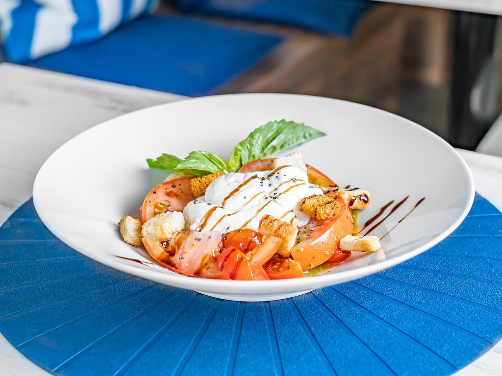 Burrata Salad · With cherry tomatoes pesto and croutons.