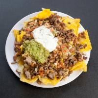 Macho Nachos · An even larger helping of our tasty chips covered with melted cheese, beans, sour cream, gua...