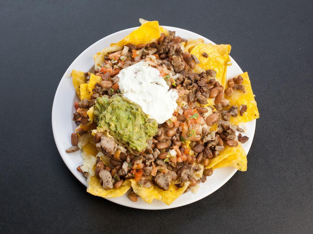 Macho Nachos · An even larger helping of our tasty chips covered with melted cheese, beans, sour cream, guacamole, pico de gallo and your choice of meat. Tilapia or prawns for an additional charge.