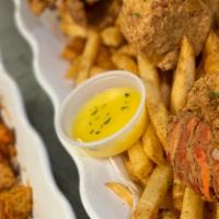 Fried Lobster Tails · 2 Seasoned, battered, and deep fried lobster tails. Served with season fries and 1 fried cor...