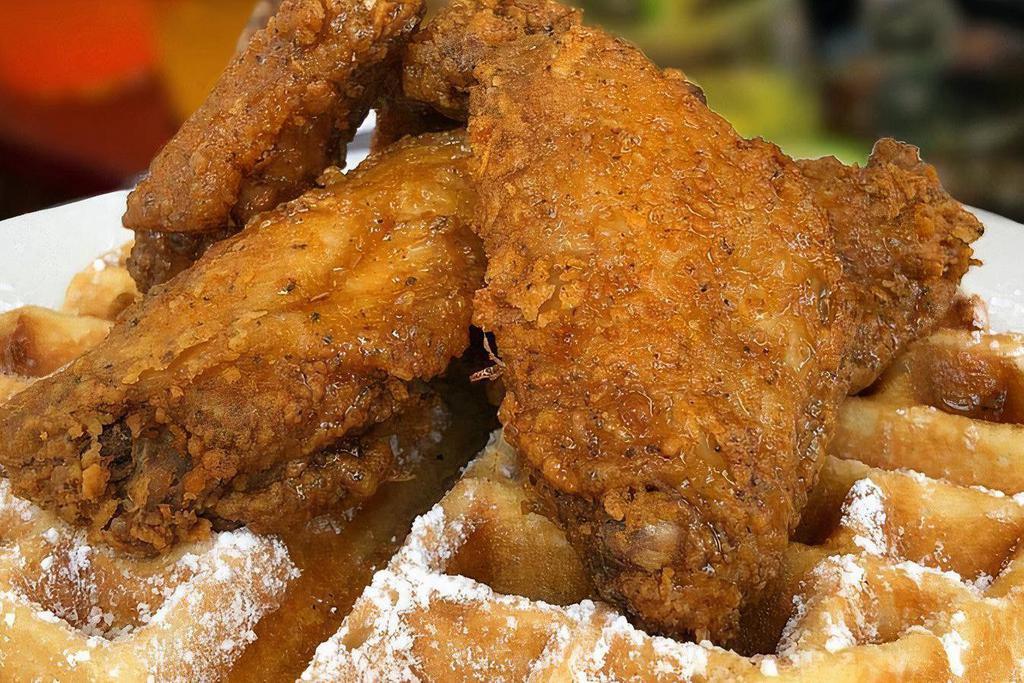 Chicken ＆ Waffles · Four seasoned deep fried golden battered chicken wings and sweet buttered waffles.