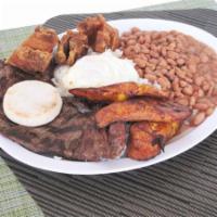 Bandeja Paisa con Carne Asada · Steak, rice, beans, fried egg, pork rind and sweet plantains.