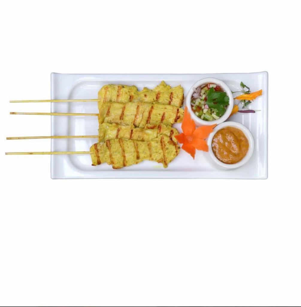 Chicken Satay · Chicken skewers marinated with curry spices. Served with homemade peanut sauce and sweet cucumber vinegar.