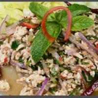 Chicken Larb Salad · Ground chicken mixed in mint leaves, roasted rice, onions, and cilantro. Served with spicy l...