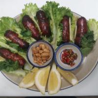 Thai Sausage ·  E-san sausage.  Served with ginger, romaine lettuce, peanut, fresh thai chili , and sliced ...