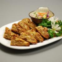Thai Toast · Shrimp covered with seasoned ground chicken, and then deep fried on toast. Served with cucum...