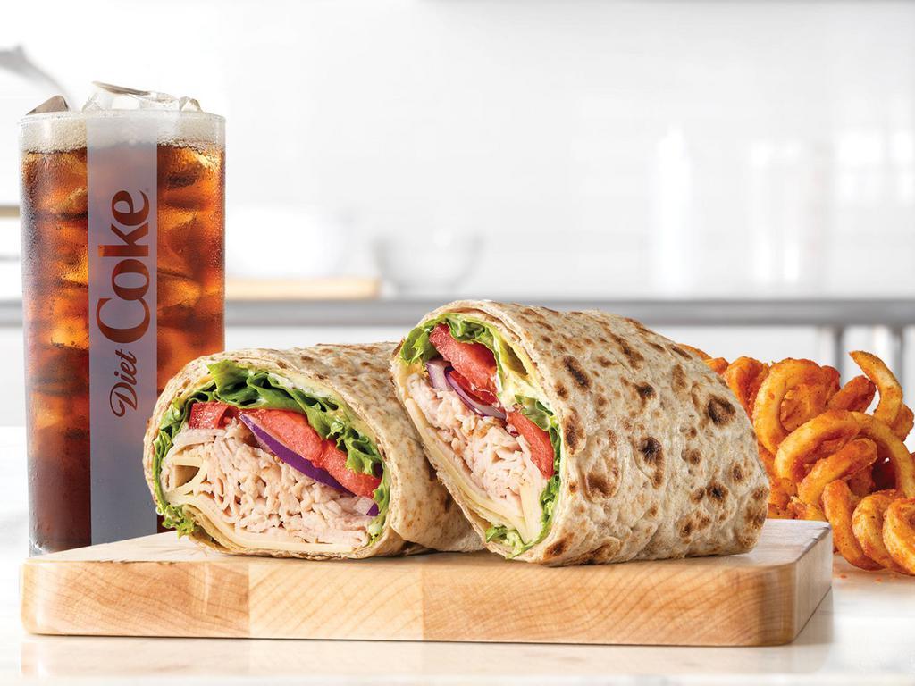 Market Fresh® Roast Turkey & Swiss Wrap Small Meal · Oven-roasted turkey, ripe tomatoes, lettuce, thinly sliced red onions, Swiss Cheese, mayo and spicy brown honey mustard. Together they make the Roast Turkey & Swiss wrap, the wrap roast turkey was made to go on. Served with a drink.