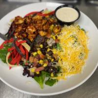 BBQ Chicken Salad · Grilled BBQ chicken piled high atop mixed greens tossed with crunchy tortilla strips, jack a...