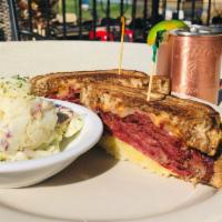 Classic Reuben Sandwich · Corned beef and Swiss cheese. Served with Thousand Island kraut.