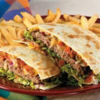 Quesadilla Burger · This burger is served between 2 grilled flour tortillas smothered with melted jack and
chedd...