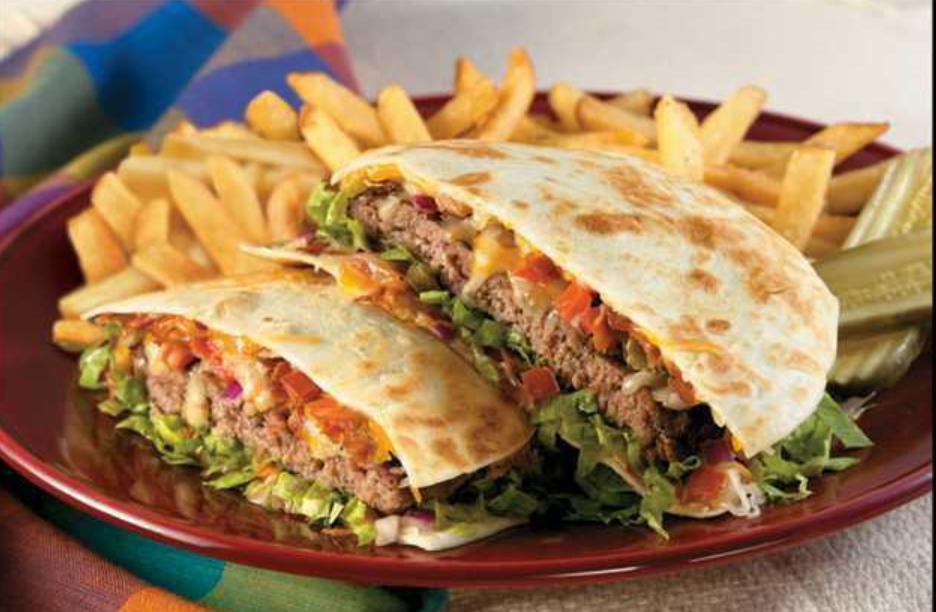 Quesadilla Burger · This burger is served between 2 grilled flour tortillas smothered with melted jack and
cheddar cheese, and pico de gallo. Finished with chopped lettuce