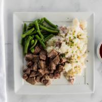 Steak and Potatoes · Sliced tenderloin, roasted garlic potatoes, green beans.