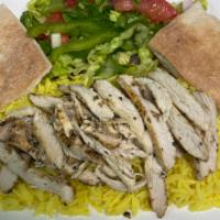 Chicken Shawarma · Chicken shawarma served with rice, salad, pita, and topped with tahini sauce.