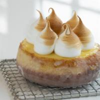 Lemon Meringue · Brioche donut with lemon cgustard cover and torched meringue on top.