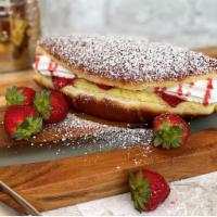 Strawberry donut croissant · Our delicious donut croissant filled with whipped cream, vanilla cream , fresh strawberry sl...
