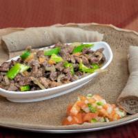 2. Tibs · Cubed cooked beef, onion, tomatoes and spices butter in Ethiopian style. Served with injera.