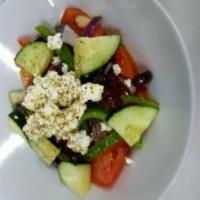 Traditional Greek Salad · Served with tomatoes, cucumbers, peppers, onions, Kalamata olives, feta cheese and extra vir...