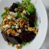 Beet Salad · Red beets, arugula, red onions, feta cheese, walnuts and balsamic vinaigrette .