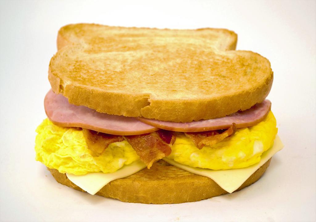 Toast Breakfast Sandwich · White or wheat toast with scrambled egg, white cheese and choice of meat.
