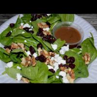 Goat Cheese Salad · Baby spinach, goat cheese, nuts, dried cranberries, and balsamic vinaigrette. Served with pi...