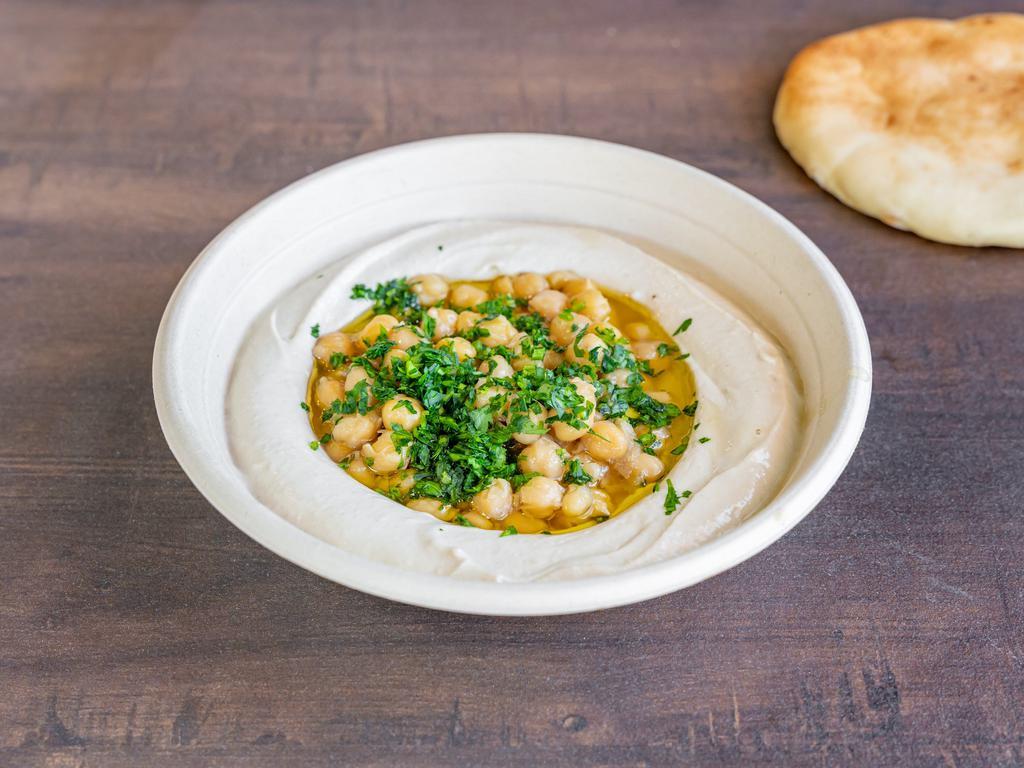 Classic Hummus · Fresh hummus dish served with cooked chickpeas, topped with olive oil fresh parsley and our Lemon sauce. Comes with fresh pita.