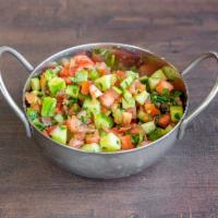 Israeli Chopped Salad · Diced tomatoes, cucumbers, red onion parsley served with lemon juice and olive oil.