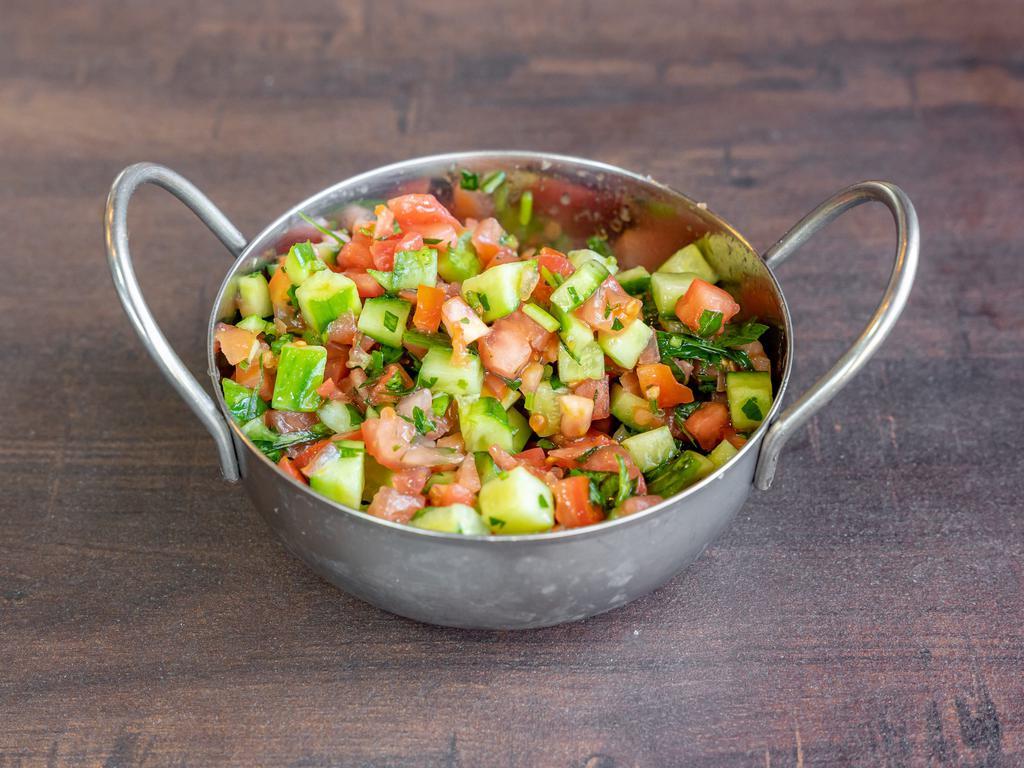 Israeli Chopped Salad · Diced tomatoes, cucumbers, red onion parsley served with lemon juice and olive oil.