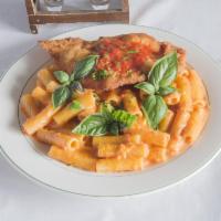 Vodka Sauce · Sauteed shallots and prosciutto flamed with vodka in a pink cream sauce with melted mozzarel...