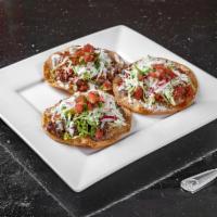 Tostadas · Flat hard sheld tortilla with beans spread, lettuce, tomato queso fresco sour cream and your...