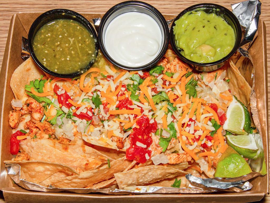 Nachos · Fresh fried tortilla chips with your choice of meat. Topped with queso, onions, cilantro, tomatoes, jalapeños, and queso fresco. Served with a side of salsa, mexican creama, and guacamole. 