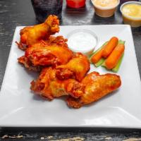 Wings · Choice of: house sauce, Buffalo, sweet chili, spicy Sriracha, or BBQ all served with blue ch...