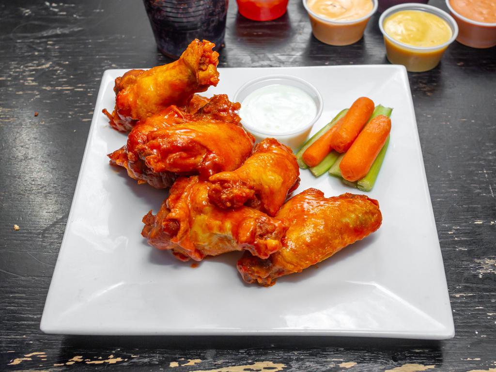 Wings · Choice of: house sauce, Buffalo, sweet chili, spicy Sriracha, or BBQ all served with blue cheese, carrots, and celery.