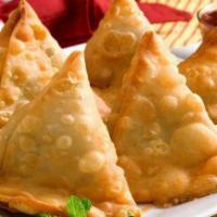 Vegetable Samosa (2) · Crisp turn over filled with spiced potatoes and peas.