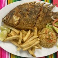 Mojarra Frita · Fried whole fish served with rice, fries and lettuce.