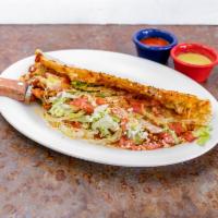 Machete · A 10 inches homemade thick tortilla folded in 1/2, filled with cheese, and meat of your choi...