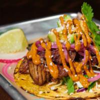 Wikea Brisket Taco · Slow cooked brisket, Cali coleslaw, diced avocado, pickled red onion, Cotija cheese, and Gra...
