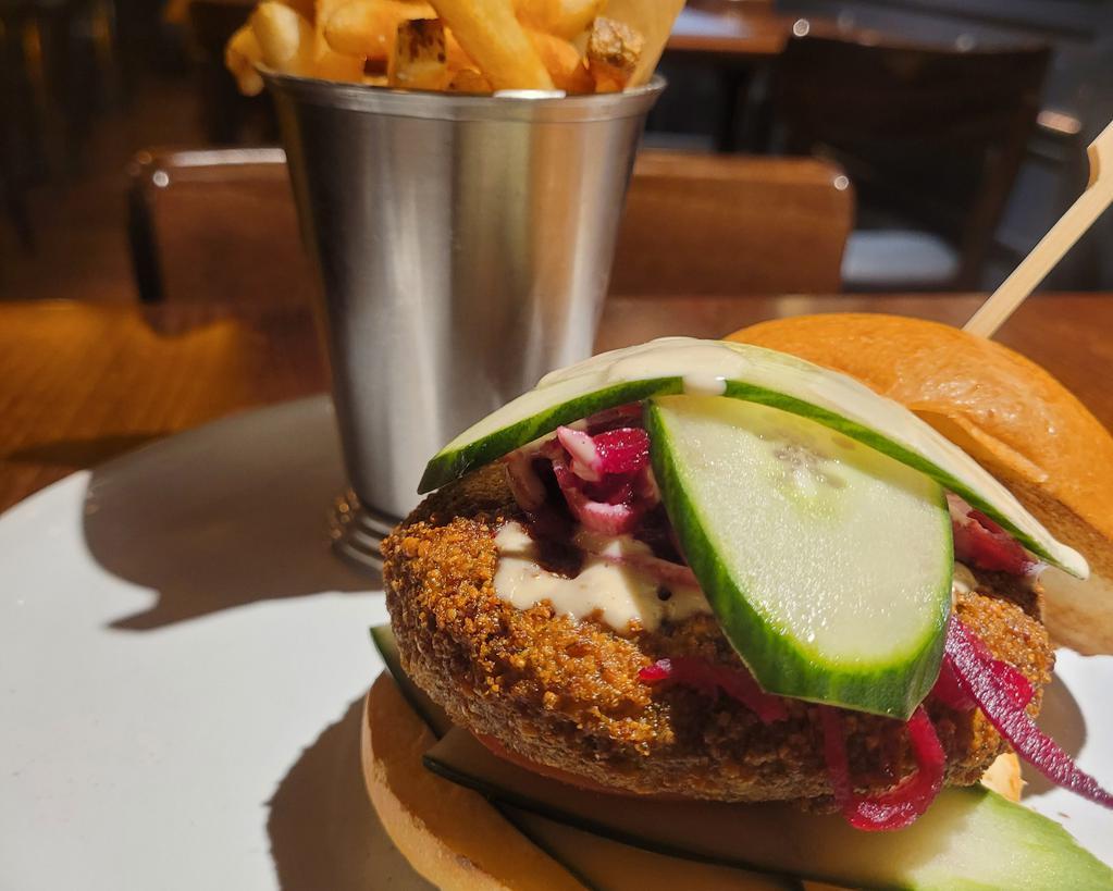 Falafel Burger · Pickled beets, tomato, cucumber, tahini dressing and brioche.