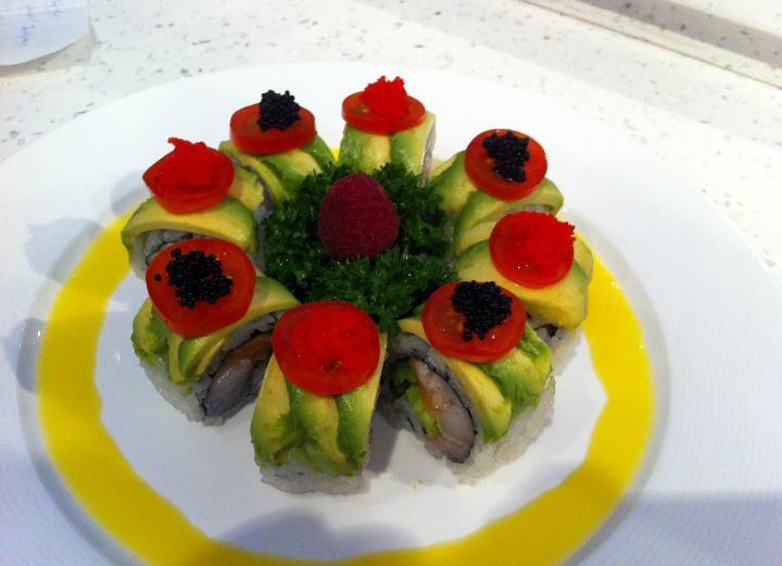 Paradise Roll · White tuna, salmon, yellowtail and jalapeno inside, topped with avocado, cherry tomato, red and black caviar with mango sauce.