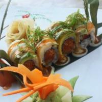 Ocean Kiss Roll · Spicy scallop, crunch and caviar inside, topped with white tuna, avocado and scallions with ...