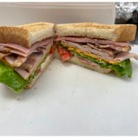 Pullen Club Sandwich · Sliced Turkey, Cooked Uncured Ham, NC Thick Cut Bacon, Lettuce, Tomatoes with Mayo on Toaste...