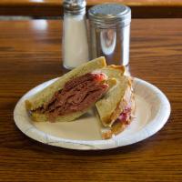 Pastrami Supreme Sandwich · Hot pastrami layered with bacon, melted Swiss cheese, lettuce, and tomato on a bagel or hero.