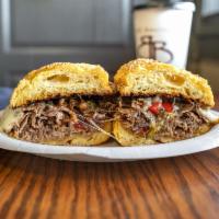 Philly Cheese Sandwich · Thin sliced roast beef, smothered with mozzarella cheese, grilled onions and peppers on a ba...