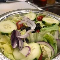 Italian House Salad · Iceberg lettuce, cucumber, black olives, tomato, red onion, fresh mozzarella with our house ...