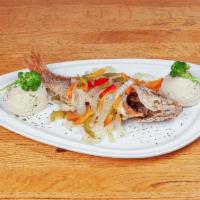 Escovitch Whiting Fish · fried whiting fillet topped with escovitch onions, peppers, and carrots.